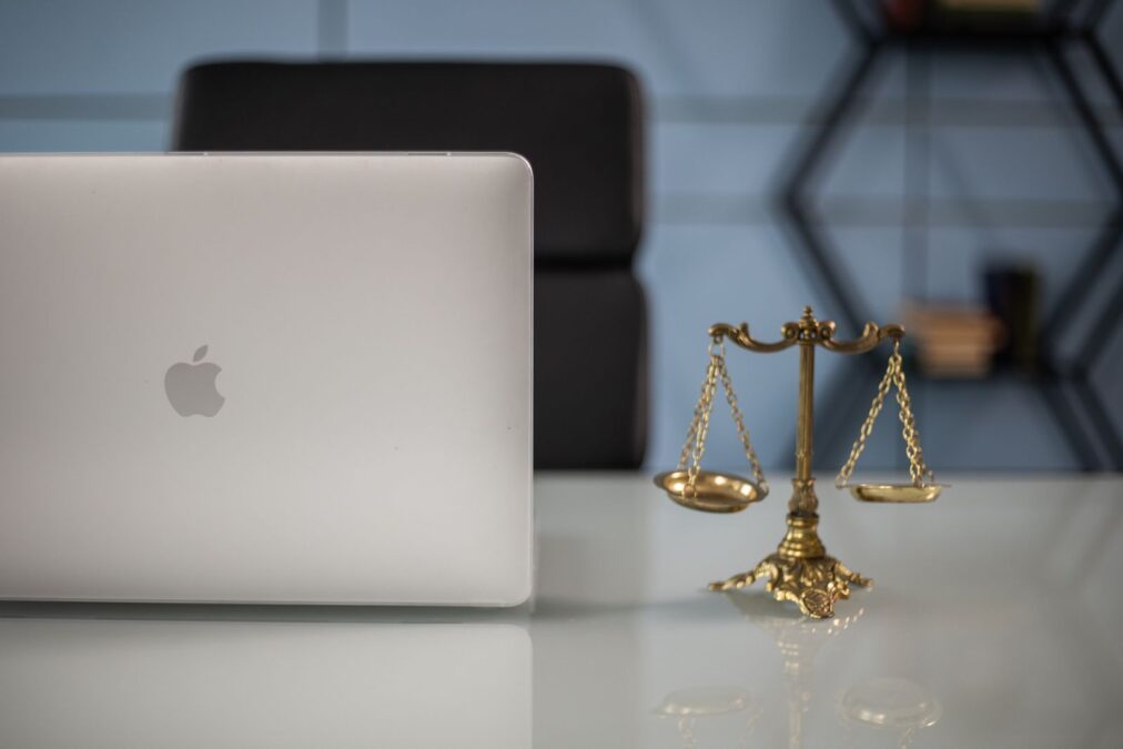 Scales of justice balanced with technology on a lawyer’s desk — agentic AI for law firms